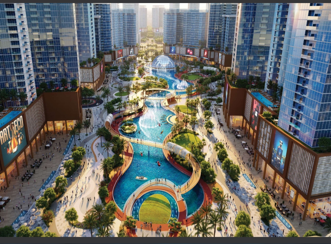Architectural render of Tiger Downtown Ajman: glass towers around a landscaped water park with fountains and a glass dome at sunset